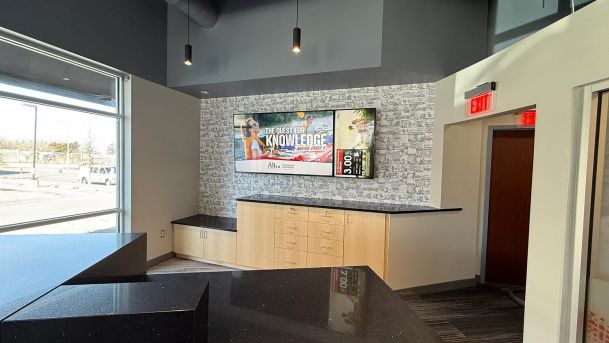 Reception area counter with a wall-mounted display screen